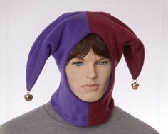 a mannequin wearing a purple and red hat with bells on it's head