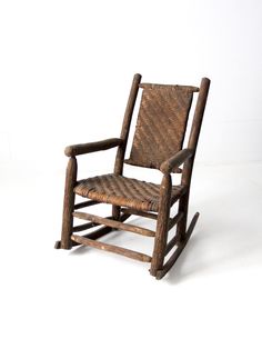 a wooden rocking chair with wicker seat and armrests on a white background