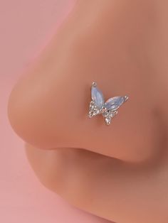 a close up view of a butterfly shaped earring on a mannequin's head