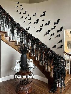 a staircase decorated with halloween decorations and bats