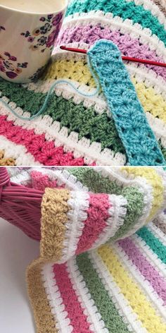 a crocheted blanket with yarn next to a coffee cup