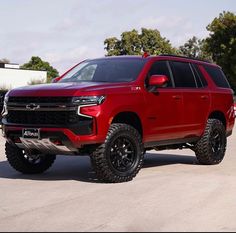 a red truck parked in a parking lot