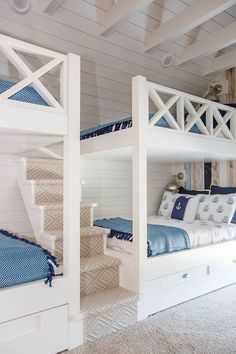 two white bunk beds sitting next to each other