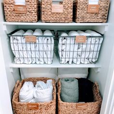 the shelves are filled with baskets and towels