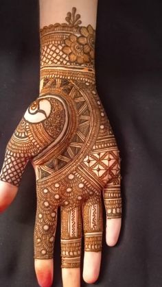 a woman's hand with hennap on it, showing the intricate design