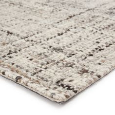 an area rug with various colors and patterns on it, including greys, browns, and whites