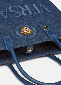 Crafted from denim canvas with leather top handles, this shopper bag is adorned with a Medusa plaque and raised logo lettering. The roomy interior has a large zipped pocket and protector strap, and the D-ring provides an optional attachment for a keyring or charm. Versace Tote Bag, Luxury Tote Bags, Suit Bag, Denim Tote Bags, Denim Tote, Handbag Shoes, Shopper Bag, Large Tote Bag, Leather Items