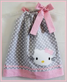 a hello kitty bag with a pink bow on the front and white polka dots on the back