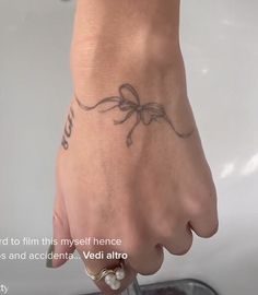 a person's hand with a tattoo on it