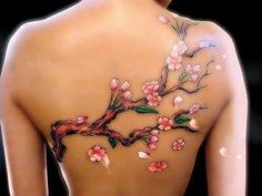 the back of a woman's body with flowers painted on it