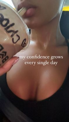 a woman holding a cup with the words, my confidence grows every single day