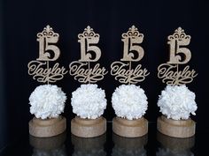 three cake toppers with flowers and the number five on them are made out of burl