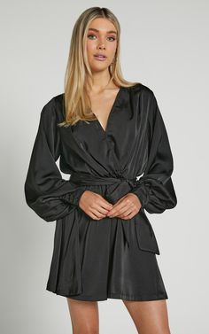 Get ready to turn heads in our Laura Mini Dress! This flirty and playful long sleeve wrap dress is perfect for a night out on the town. With its sultry V neck and figure-flattering silhouette, you'll feel confident and sexy all night long. The black color adds a touch of sophistication, making it the ideal choice for any party or special occasion. Whether you're hitting the dance floor or sipping cocktails with friends, this mini dress will have you looking effortlessly chic. So go ahead and mak Flirty Wrap Dress For Date Night, Flirty Wrap Dress, Faux Wrap Dress With Surplice Neckline For Night Out, Flirty Long Sleeve Mini Dress For Going Out, Fall Date Night Wrap Dress With Long Sleeves, Fall Date Night Long Sleeve Wrap Dress, Long Sleeve Wrap Dress For Date Night, Fall Cocktail Wrap Dress With Surplice Neckline, Sleek Long Sleeve Mini Dress For Cocktail