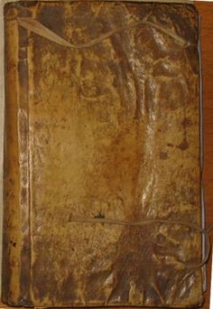 an old book sitting on top of a wooden table