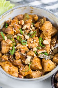 a white bowl filled with chicken and vegetables