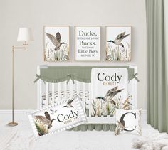 a baby crib bedding set with birds on it, and two pillows in front of the crib