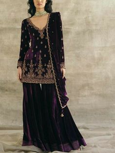 Beautiful short embroidered velvet kurti with flair velvet sharara is perfect for winter wedding and festival. Elegant plum colour velvet sharara suit  🌸KURTA This beautiful velvet kurti has zari,beads embroidery over the neck, sleeves and hem line. It has small motifs all over the front BOTTOM Flair velvet garara with crepe lining 🌸Lace dupatta The dupatta will have lace border on all for side, and the fabric will be orgenza.  🌸Embroidery dupatta For this the dupatta will be of velvet fabric with same beads handwork as in the picture.  👉please check the dupatta description before making purchase.  ✨If you want any changes in the outfit please contact us we will guide you as per your preference.  ✨We assure you that we use only high quality fabric and threads to make any dress and you Velvet Sharara Suit, Velvet Sharara, Sureena Chowdhri, Velvet Kurti, Velvet Suit Design, Gharara Designs, Velvet Kurta, Velvet Dress Designs, Salwar Kamiz