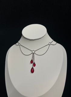 Elegant and refined, this necklace will highlight your neck. --------------------------- Fine mesh chain 0.2 x 0.3 mm in stainless steel Extension chain 2 x 3 mm in stainless steel Glass drop beads 15 x 8 mm for the large one, 10 x 5 mm for the small ones Zinc alloy clasps and connectors Minimum length: 30 cm* Maximum length: 40 cm* ⚠ All my jewelry is assembled by hand Jewelry resistant to time provided you take care of it, avoid contact with water. *Can be personalized --------------------------- ✺ Carefully packaged in tissue paper, slipped into an organza pouch and sent in a bubble wrap pouch, perfect as a gift! ✺ Reactive deposit, sending by followed green letter (FRANCE) --------------------------- ✺ Do not hesitate to contact me with any questions! --------------------------- Adjust Vampiric Jewelry, Necklace Blood, Vampire Necklace, Vampire Jewelry, Steel Extension, Blood Drop, Beaded Necklace Designs, Organza Pouch, Handmade Jewelry Tutorials