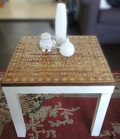 a coffee table with two vases on it