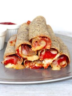 there is a plate with some food on it and the words baked pizza taquitos