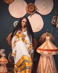 The beauty of Ethiopian traditional dress is truly a sight to behold, and the stunning yellow color of this particular garment is simply breathtaking. The dress features a flowing silhouette that drapes elegantly over the body, with intricate embroidery and beading adding texture and dimension to the fabric. The yellow color of the dress is bright and vibrant, evoking images of sunshine and warmth. As the wearer moves, the dress catches the light and shimmers, creating a truly mesmerizing effect Traditional Yellow Dress For Festivals, Traditional Yellow Floor-length Dress, Traditional Yellow Dress For Ceremonies, Traditional Yellow Maxi Dress For Wedding, Yellow Traditional Drape Gown, Floor-length Yellow Dress For Festivals, Gold Dresses With Traditional Patterns For Ceremonies, Traditional Yellow Maxi Length Gown, Traditional Long Sleeve Yellow Gown