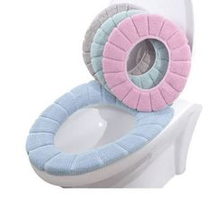 the toilet seat cover is made out of two different colored pieces of material, one with a pink and blue ring on it