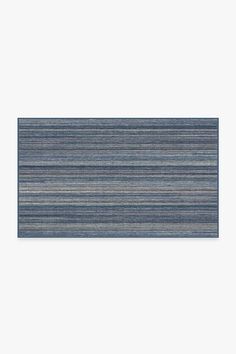 a blue and grey striped rug on a white background