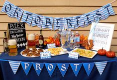 a table topped with lots of food next to a sign that says oktoberfest