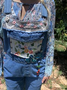 These adorable overalls are truly vintage, I remember the Bum brand in the 1970's as being one of the cool brands to have. These are a size small, but because overalls are designed to fit loosely and can be adjusted in a variety of ways (straps, buttons on the side, etc.) I would estimate these could fit a tall size 4 up to a size 10 in women's sizes. The pocket of the bib I added vintage embroidered linen of flowers and leaves. At the top of the bib, there was a logo that I didn't like so I put Bohemian Overalls With Pockets For Spring, Casual Patchwork Overalls For Festival, Casual Festival Overalls With Patchwork, Spring Hippie Cotton Jumpsuits And Rompers, Spring Cotton Jumpsuits And Rompers, Hippie Style, Spring Cotton Jumpsuits And Rompers In Hippie Style, Cotton Overalls With Pockets For Festival, Vintage Bib Front Shortalls For Spring, Vintage Cotton Overalls, Upcycled