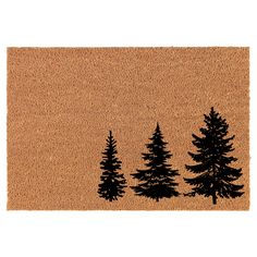 a door mat with three trees on the front and one pine tree on the back