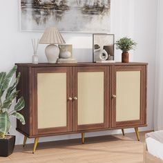 a wooden cabinet with two doors and some plants on top of it in front of a painting