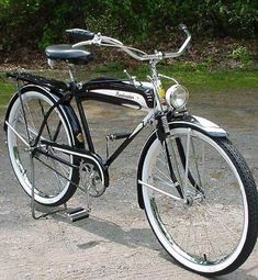 a black and white bicycle is parked on the pavement