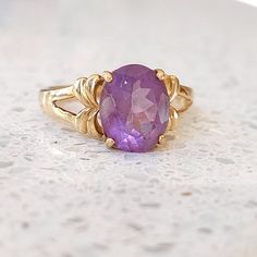 Beautiful solid yellow 9 ct gold vintage ring set with a large, subtle lilac, Amethyst gemstone. Fully UK hallmarked. INTERNATIONAL BUYERS - please read the shipping information below. Follow us on Instagram for all our latest pieces and first Dibs! They don't all make it to our Etsy store: https://www.instagram.com/mooreperfectpieces/ Hallmarked 9 ct gold. GTV Makers mark. Birmingham assay mark.  Size UK B 1/2 US 7 Eu 55 - suitable for resizing.  weight 3.54 g The face of the amethyst measures Classic Amethyst Ring Stamped 14k, Classic Purple Ring As Gift, Classic Purple Rings As Gift, Timeless Gold Amethyst Ring, Timeless Gold Oval Amethyst Ring, Timeless Oval Gold Amethyst Ring, Classic Oval Purple Birthstone Ring, Fine Jewelry Lavender Hallmarked Rings, Classic Oval Purple Amethyst Ring