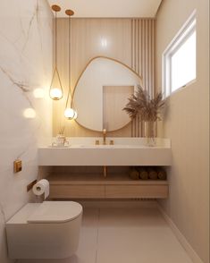 a white toilet sitting next to a bathroom sink under a round mirror in a bathroom