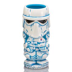 a white and blue ceramic mug with a storm trooper on it's face in front of a white background