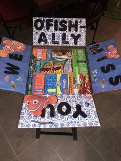 a table that has some books on it and the words fish ally written in black