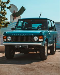 a blue truck parked in front of a building