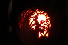 a carved pumpkin with the image of a man's face and name on it