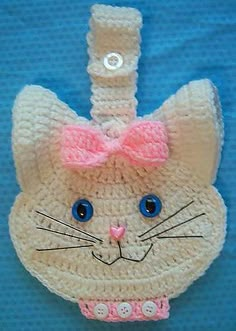 a crocheted cat ornament with a pink bow on it's head