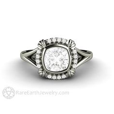 a white gold ring with an oval cut diamond surrounded by round diamonds