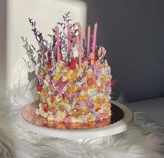 a birthday cake with flowers and candles on it