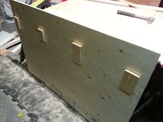 an unfinished wooden box is being worked on