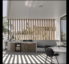 an outdoor kitchen with wooden slats on the wall