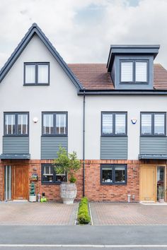 the front of a two story house with windows on each side