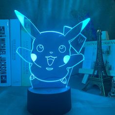 a blue light up pokemon figure sitting on top of a table