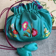 Style: handmade drawstring silk bag embroidered with flowers, eight compartments for jewelry storage, exceptional workmanship Material: silk Method: Embroider on silk Type: drawstring silk bag Size: H4", diameter 8" Green Bags With Floral Embroidery As A Gift, Festival Embroidered Green Potli Bag, Traditional Green Pouch Potli Bag, Traditional Green Potli Pouch Bag, Green Traditional Bag With Floral Embroidery, Green Pouch Potli Bag As Gift, Green Pouch Potli Bag For Gift, Gift Floral Embroidered Potli Pouch Bag, Traditional Green Potli Bag As Gift