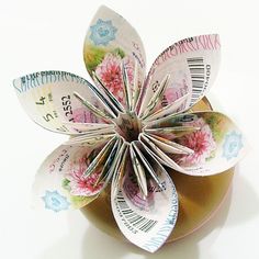 a flower made out of money sitting on top of a jar