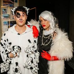 a man and woman dressed up as dalmatian dogs