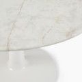 a white marble table with an oval base