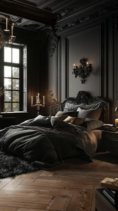 a bedroom with black walls and wooden floors, large bed in the center surrounded by dark colored linens